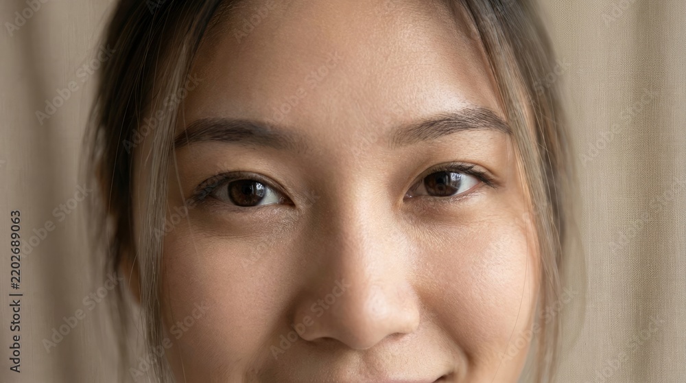 Fototapeta premium Close up portrait of a young woman with natural skin texture and glowing eyes