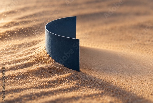 Curved Blue Barrier Holding Back Windblown Sand