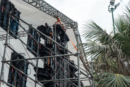 Outdoor concert stage scaffolding under cloudy sky