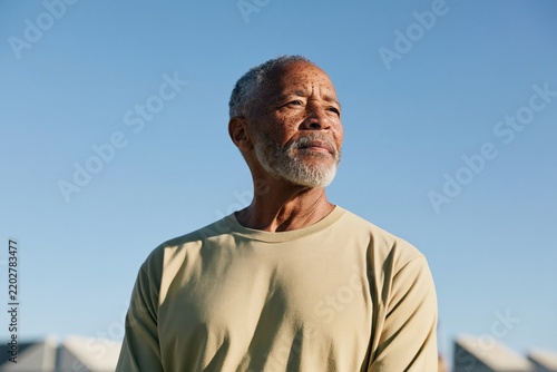 Elderly man side profile portrait outdoors with warm sunlight for banner background and senior care website hero design