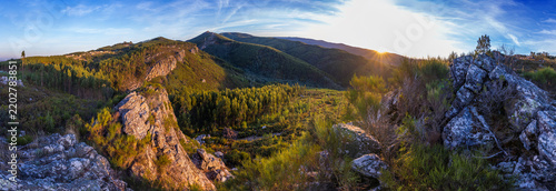 A breathtaking panoramic sunset view captures rugged mountain peaks