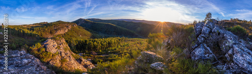 A breathtaking panoramic sunset view captures rugged mountain peaks