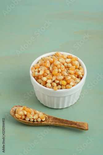 bowl of popcorn kernel seeds with a spoon