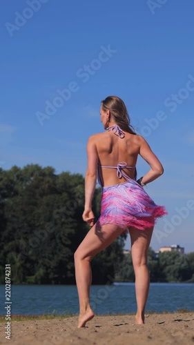 Vertical Young Tanned Beauty in Bikini Sunbathing on the Beach, Enjoying the Warm Summer Sun and Ocean
