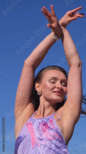 Vertical Tanned Young Woman Enjoying a Relaxing Summer Day by the Riverside, Dancing and Taking a Break from Everyday Life
