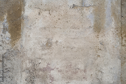 Weathered beige and off white rendered wall texture with worn patches and stains