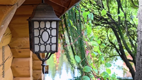 An exterior light fixture hangs from the side of a building