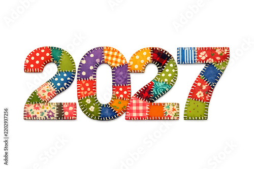 Colorful patchwork quilt style numbers representing the year 2027 isolated on a solid black background for celebration