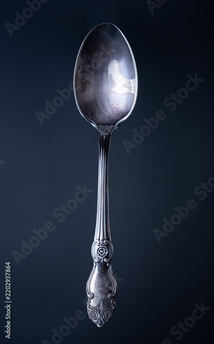 Silver spoon close up  on a black background