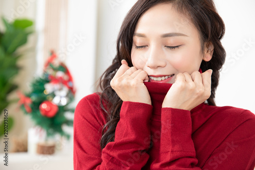 Happy Young Woman in Red Sweater Feeling Cozy at Home During Winter