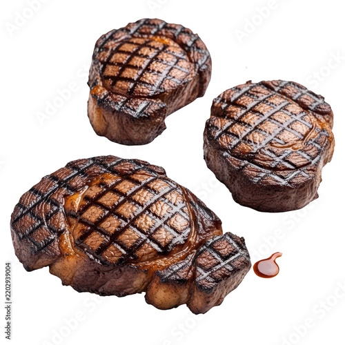 Three grilled beef steaks with sear marks isolated on clear transparent backgrounds.