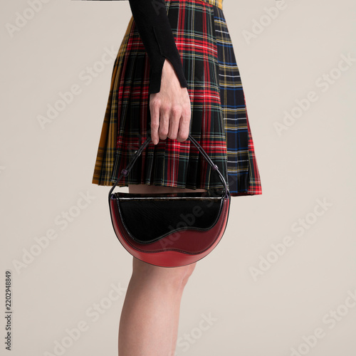 Hand Holding Handbag With Plaid Skirt