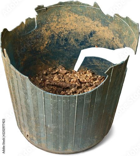 dirty broken plastic plant pot isolated white background, old green container with soil and cracked edges in close-up view