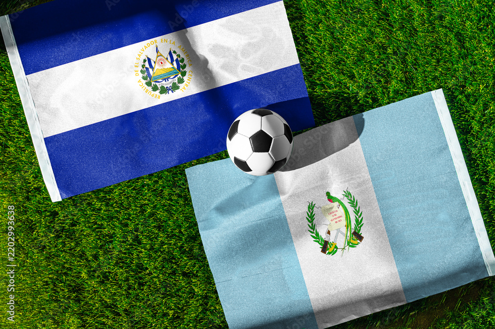 Obraz premium El Salvador vs. Guatemala football match. National flags on green grass with soccer ball in the middle. Football background for international match.