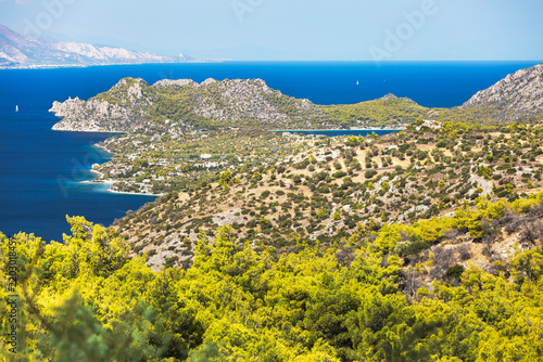 Spectacular Aerial Coastal Landscape with Vouliagmeni Lake and Heraion, Loutraki, Greece, featuring the dramatic coastal landscape, Vouliagmeni Lake, and a lighthouse in the distance