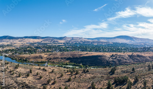Aerial view of the Klamath River meandering through a dry, vegetated terrain in Klamath County Oregon with rolling hills.