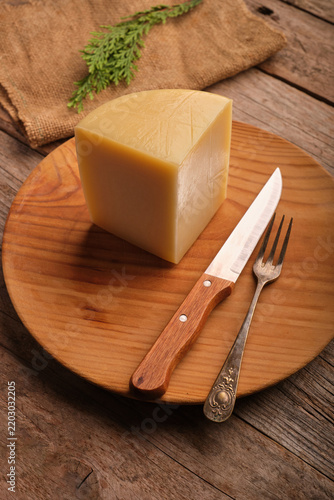 Spanish Aged Cheese With Idiazabal Designation on a Wooden Plate