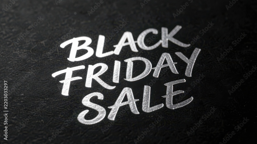 Fototapeta premium bold metallic silver calligraphy black friday sale on textured matte cardstock for premium advertising copy space