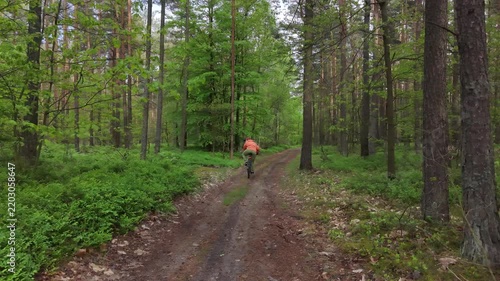 Active cyclist exploring countryside mountain bike path