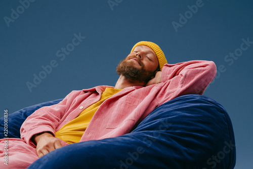 Relaxed Bearded Man Resting in Colorful Chair