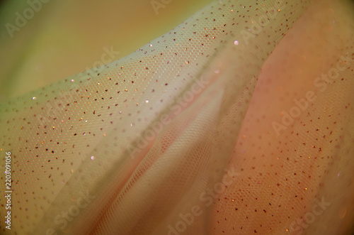 A delicate pastel background. A screen saver with fabric. A festive decoration. Light and bokeh. Yellow color. A card for a wedding, engagement, or March 8th. Template and copy space.