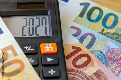 Euro currency in 2027 year. Financial business concept. Money and calculator with date 2027. Market analysis Eurozone.  exchange rate. Economic background. closeup