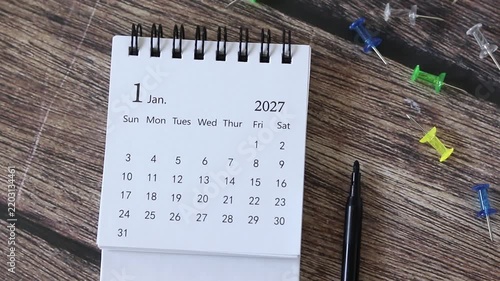 2027 calendar on a wooden desk. New year plan, goals, and resolutions concept.