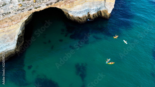 Принти на полотні Amazing scenic drone aerial view of the beach and ocean with calm waves during a sunset with vibrant colors
