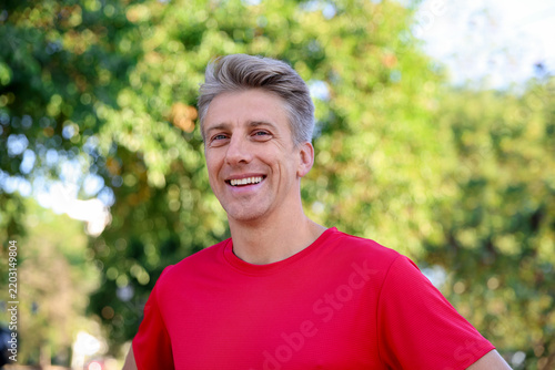 Smiling sporty man before run in park