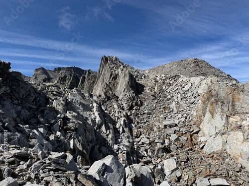 Rugged rock formations and giant granite boulders along a high-altitude hiking route in the Swiss Alps near Realp in the canton of Uri, showing steep cliffs, alpine terrain and dramatic geology