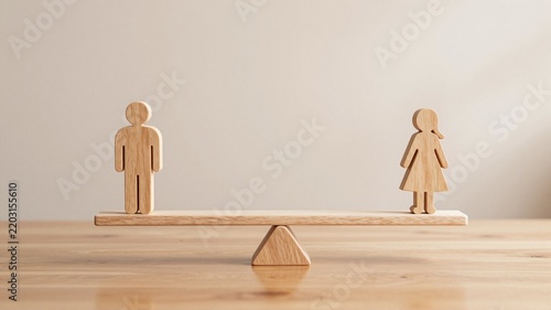 Wooden figures of a man and a woman balancing on a seesaw