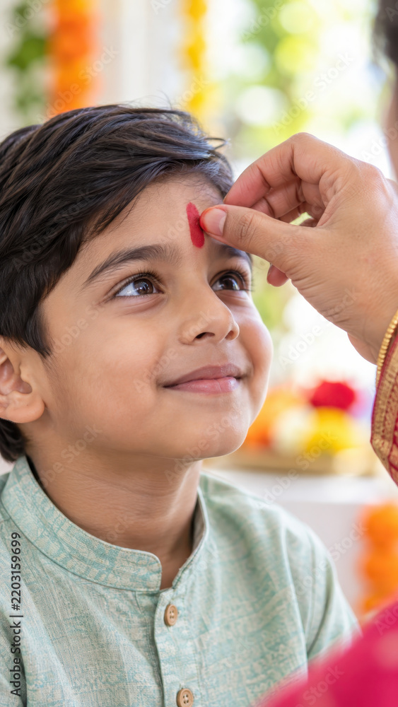 Fototapeta premium Warm festive home setting prepared with mother applying sacred tilak to smiling child forehead for dussehra focused on blessing ritual under peaceful festive ambience