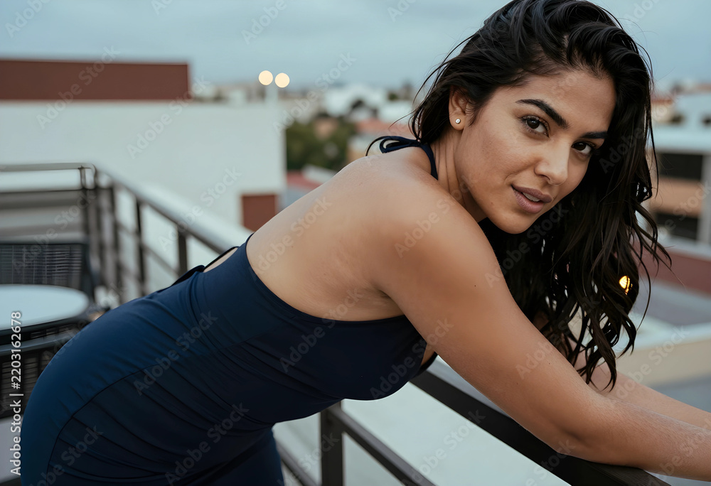 Fototapeta premium Wellness and self care, young woman relaxing on a balcony at sunset enjoying city lifestyle and evening leisure time in a modern urban environment