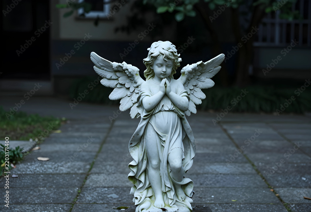 Obraz premium Spirituality and peace stone angel statue with praying hands in a quiet garden setting for memorial funeral and religious reflection concepts