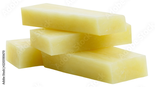 Isolated stack of smooth, pale yellow rectangular blocks, resembling industrial wax or soap base.