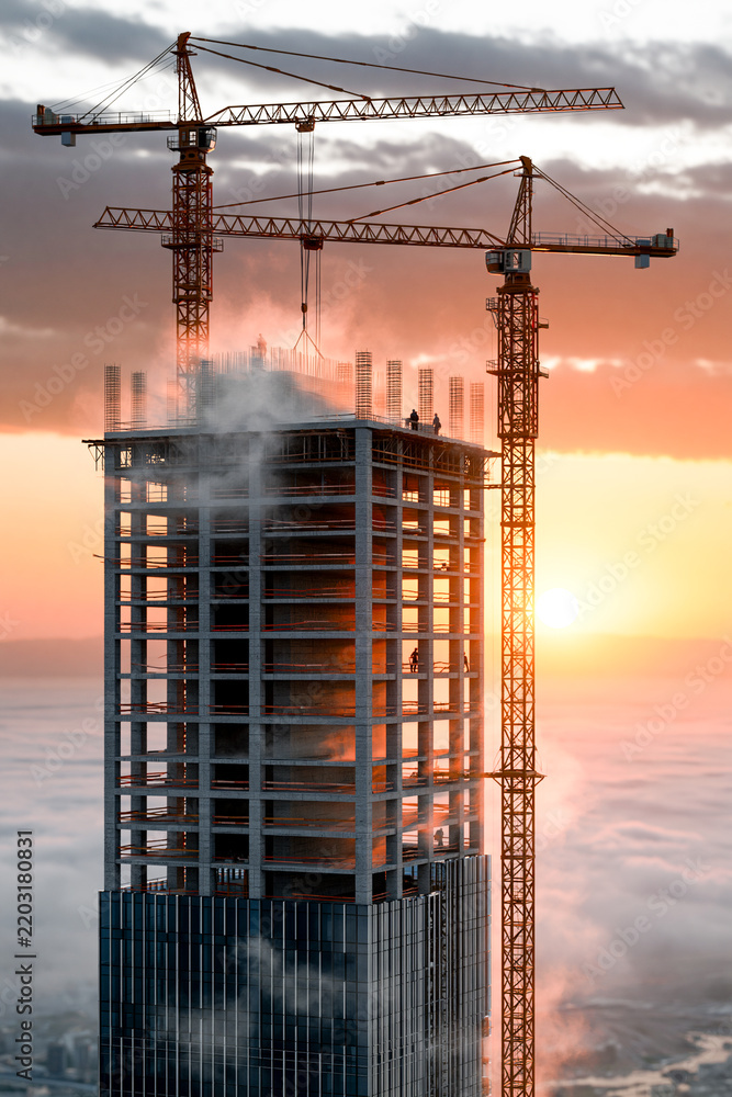 Obraz premium High angle view of a modern skyscraper under construction with tower cranes above a dense layer of white morning fog at golden sunrise, representing urban growth and business.