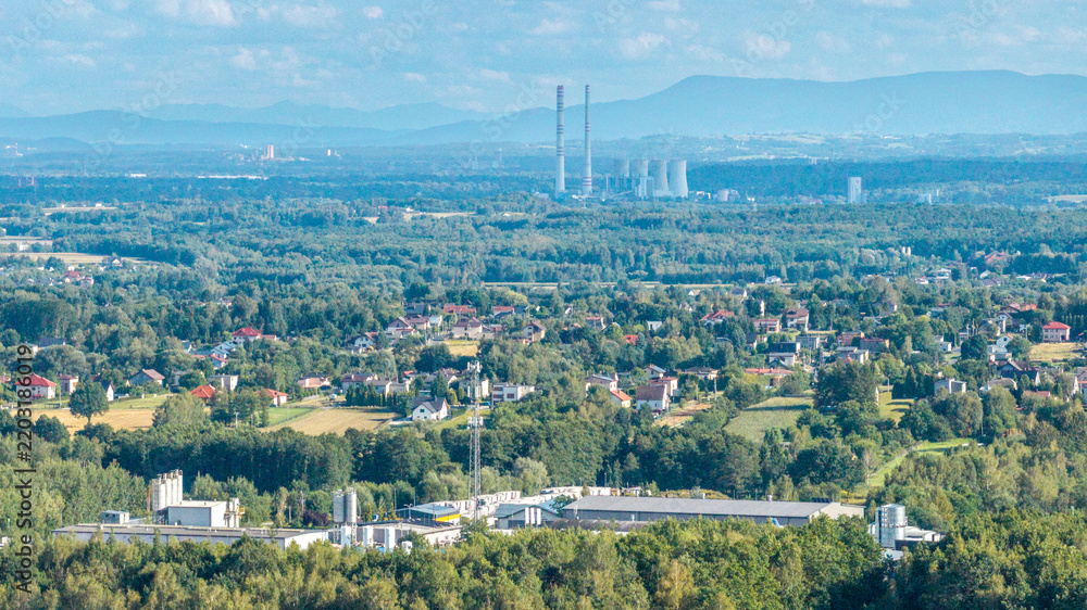 Fototapeta premium Rybnik landscape showing power plant chimneys, residential area, and forests