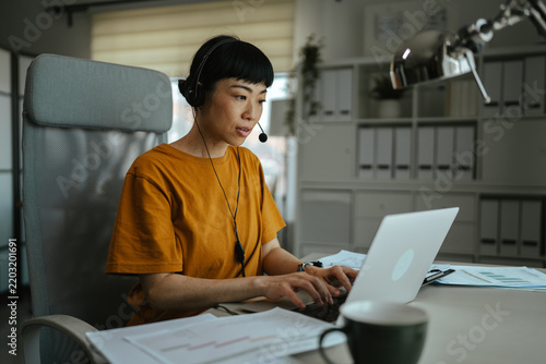 Asian woman working remotely having online meeting