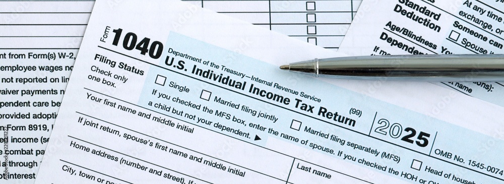 Fototapeta premium 1040 US Individual Income tax return blank form and pen on accountants table
