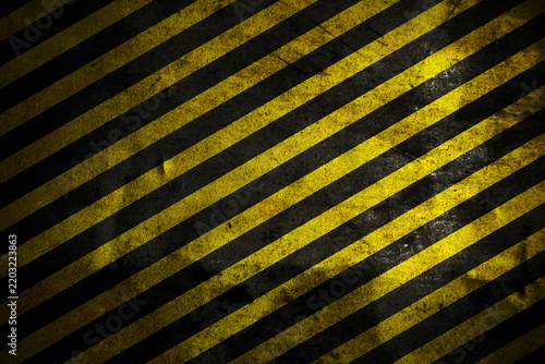 Grunge industrial hazard stripes background with diagonal black and yellow warning lines on a distressed metal surface. Safety texture ideal for construction, banners, and industrial design projects.