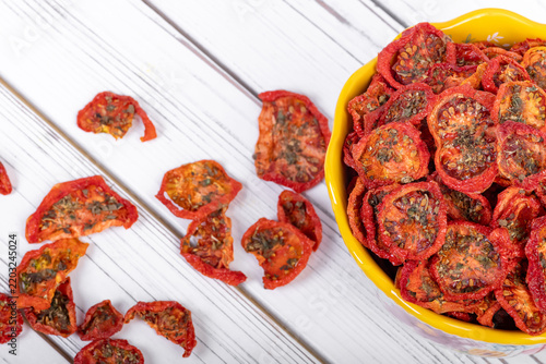 Bowl with dehydrated red fragrant tomatoes with herbs and spices.