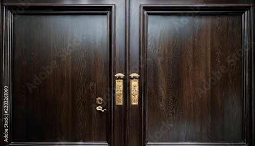 a heavy dark wooden door with a brass nameplate reading dean s office
