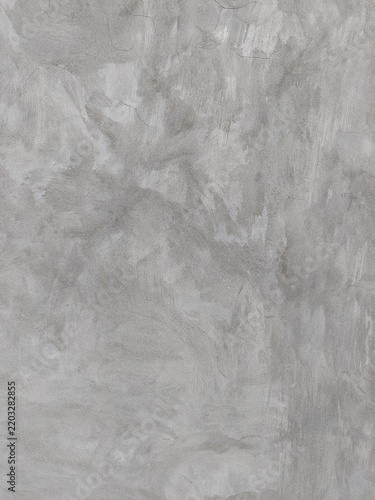 Polished grey concrete wall background with swirl brush strokes texture