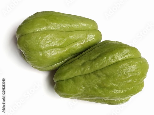 Two fresh green chayote squashes isolated on white background