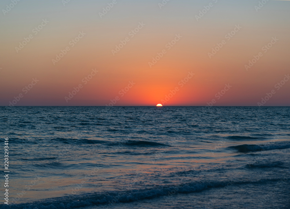 Fototapeta premium Sea sunset horizon. Sunset cloudy sky. Seascape at summer vacation. Caribbean sea. Skyscape with sea horizon. Horizon sunrise sea with waves. Sunrise seascape. Romantic summer vacation seascape