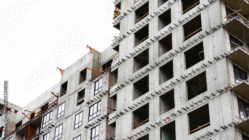 Multi story residential building under construction showing unfinished concrete structure, construction progress and urban development, representing real estate projects, architecture and modern city 
