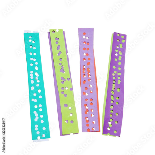 Four colorful vertical paper strips with punched holes isolated on a transparent background