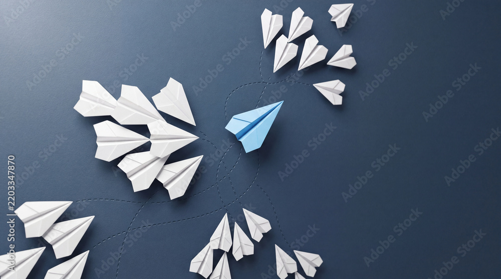 Fototapeta premium Conceptual Business Illustration of a Single Blue Paper Plane Flying in a Different Direction from a Group of White Planes Representing Leadership, Innovation, Individuality, and New Strategy