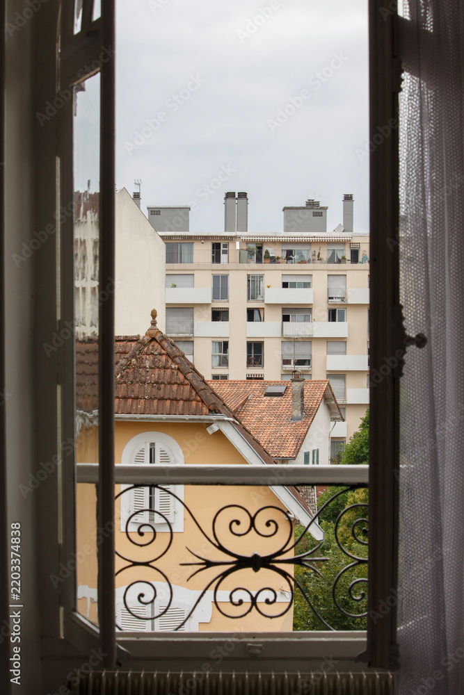 Fototapeta premium Point Of View Overlooking French House and Apartment Building From Tall Open Window With Balconet