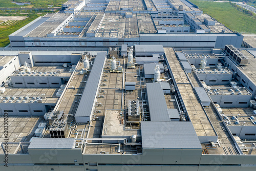 Aerial view of large industrial factory roof with various equipment and facilities
